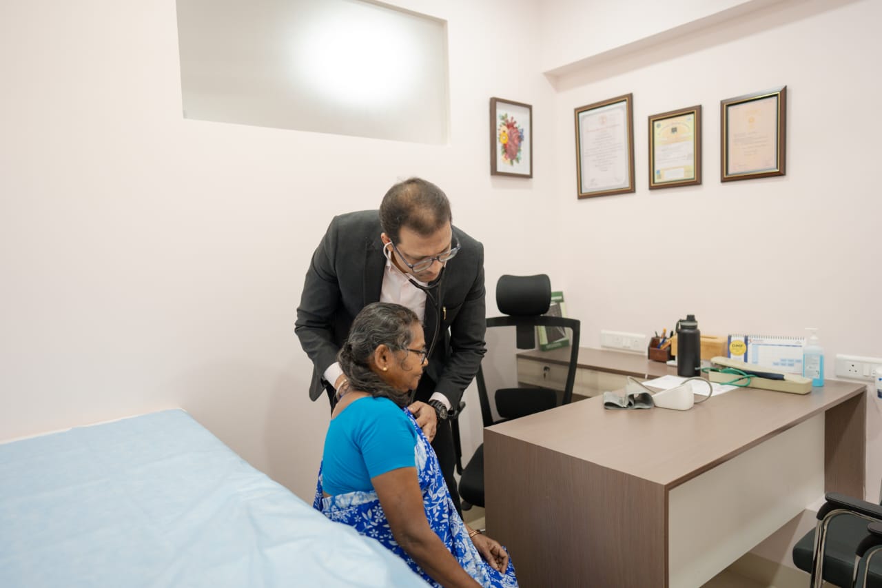 Dr. Mukul examining a patient at Sugata Clinic