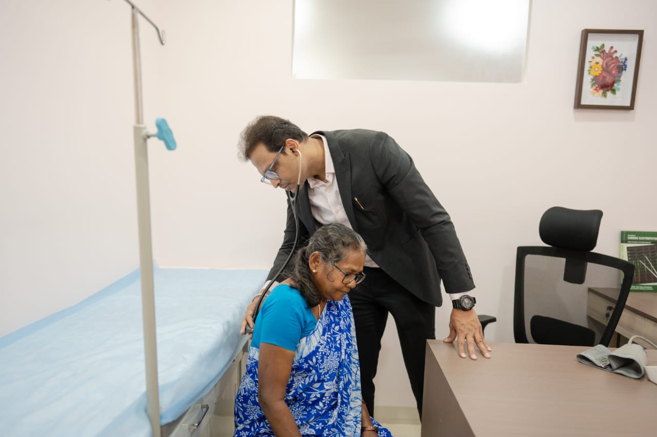 Dr. Mukul attending to an elderly patient at Sugata Clinic